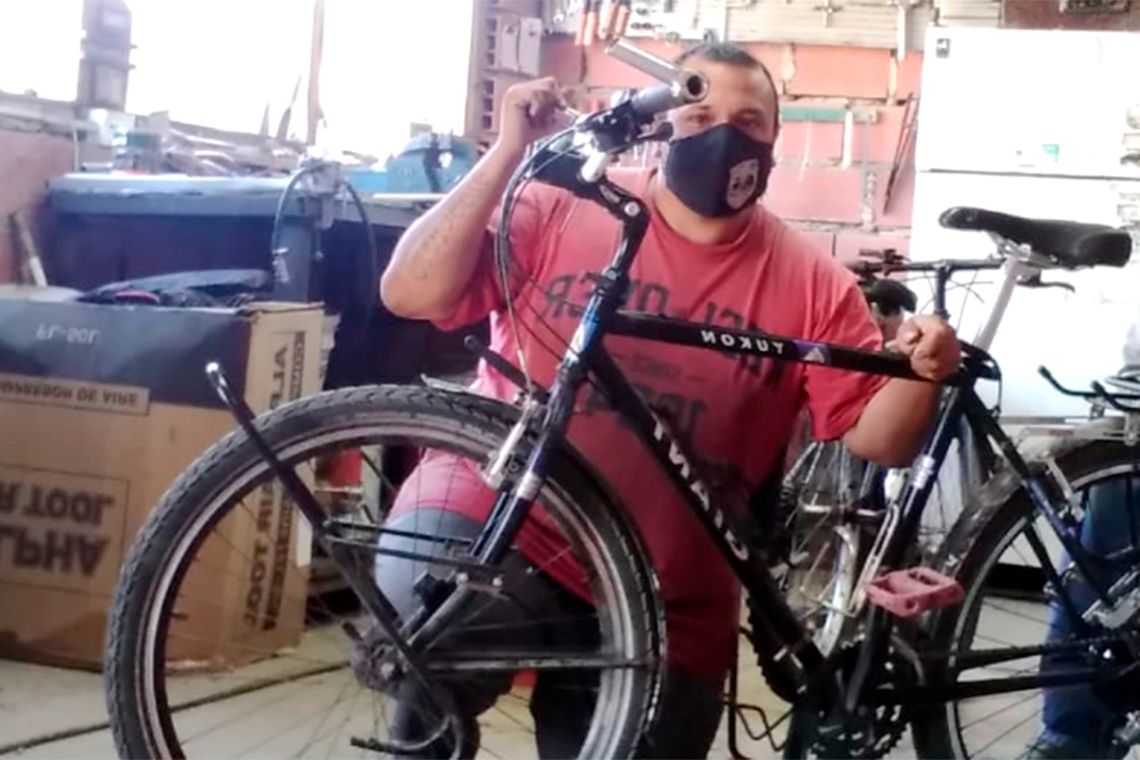Germán Neculman, de 39 años, alistando su bicicleta antes de comenzar su travesía.